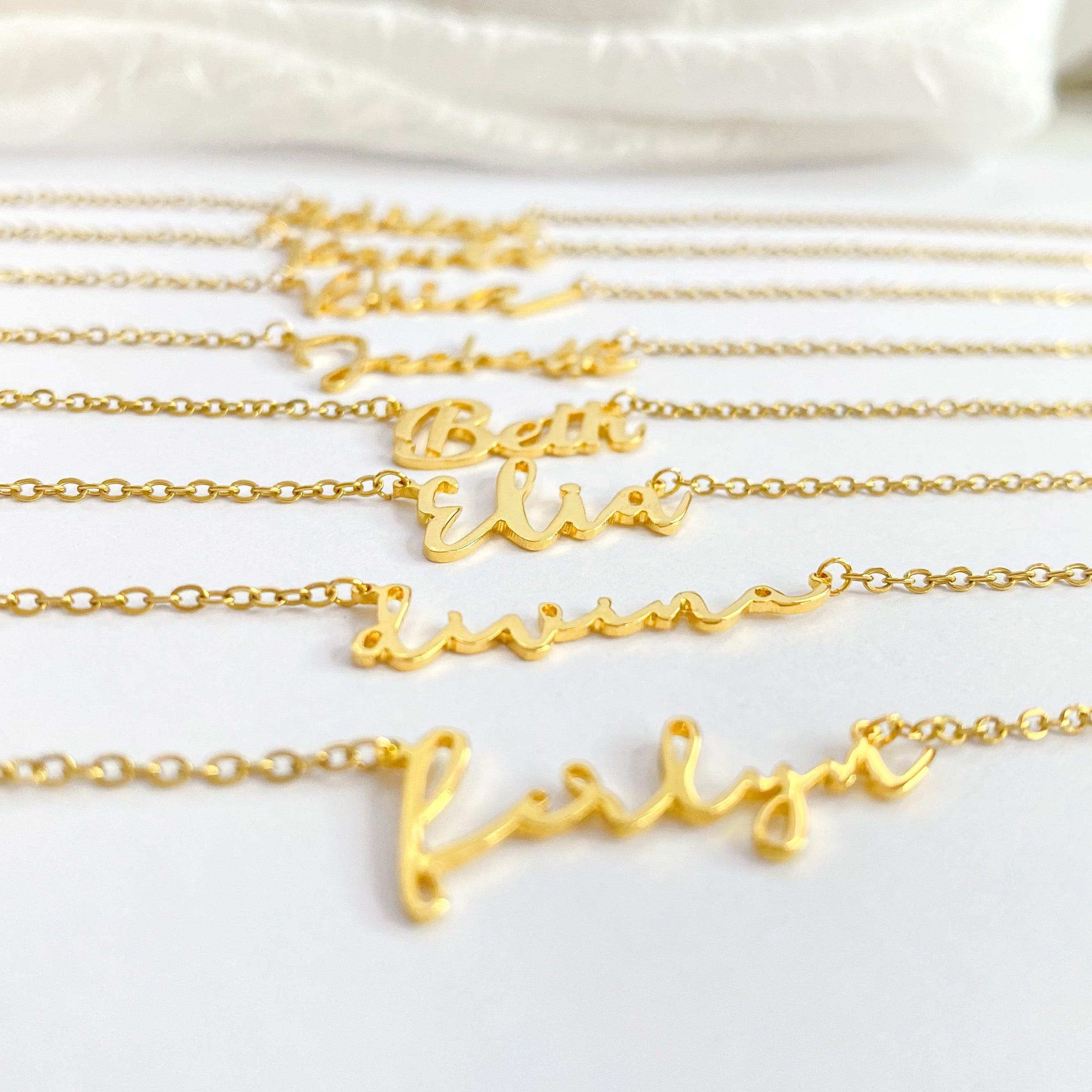 Gold name necklace with multiple name plates in script font